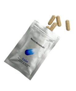 Close up of uniform clear vegetable capsules filled with a finely ground Calm blend botanical powder